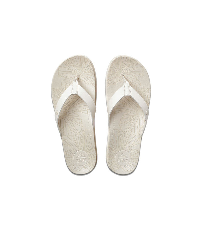 A pair of white sandals with a tropical footbed pattern, designed for women.
