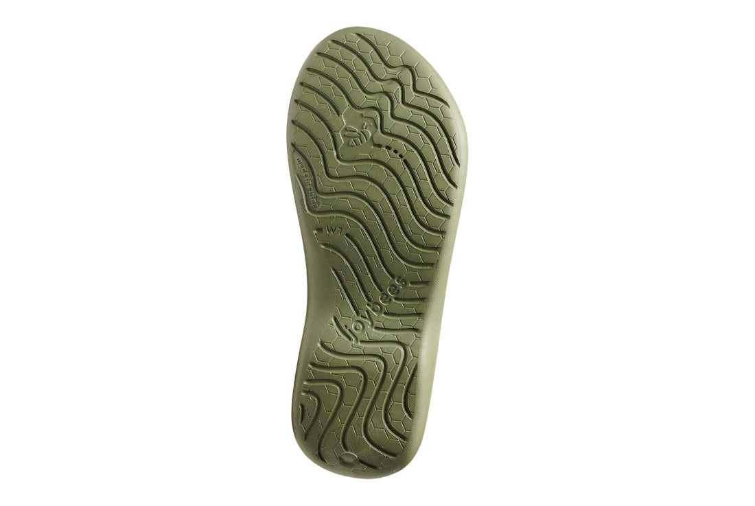 Green shoe sole with tread pattern on a white background.