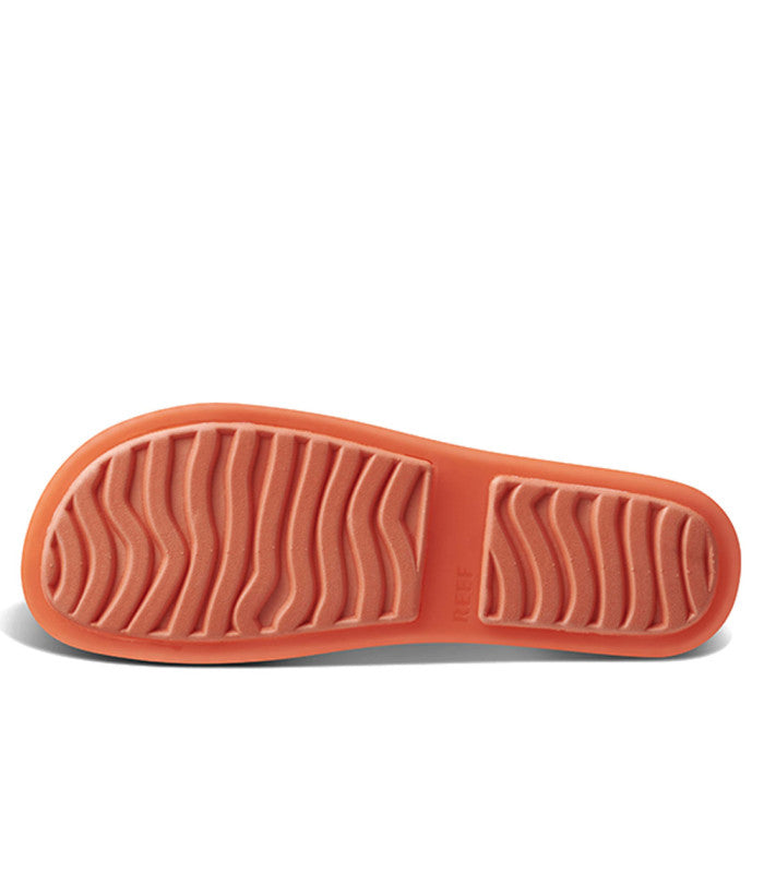 An outsole of a neon sandal.