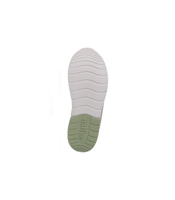 An outsole of a white sneaker with green accents.